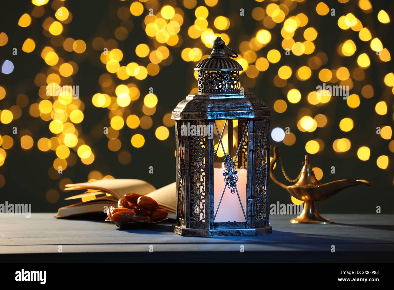 Arabic lantern, Quran, dates and Aladdin magic lamp on table against ...