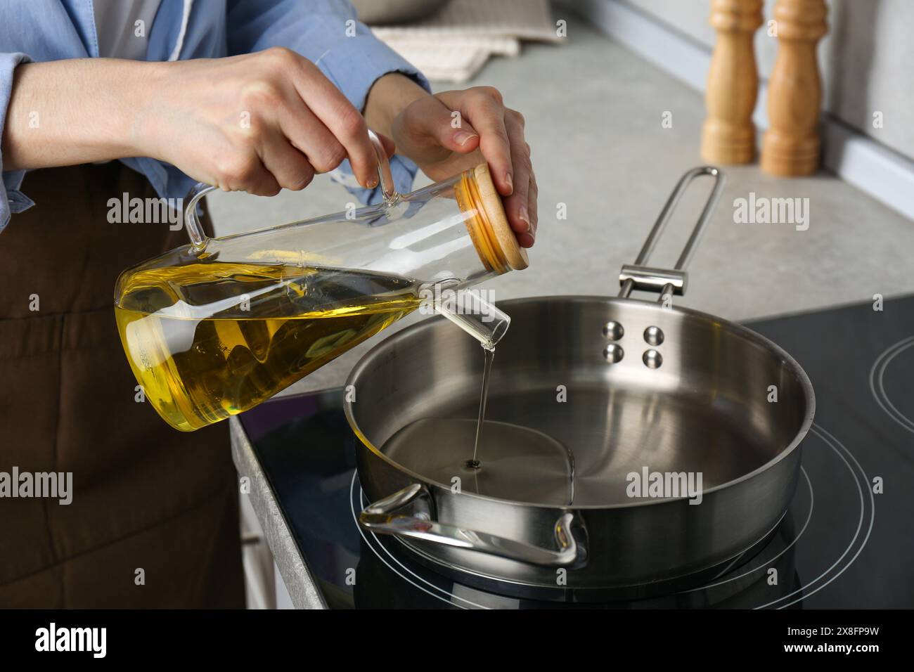 Woman pouring cooking oil hi-res stock photography and images - Alamy