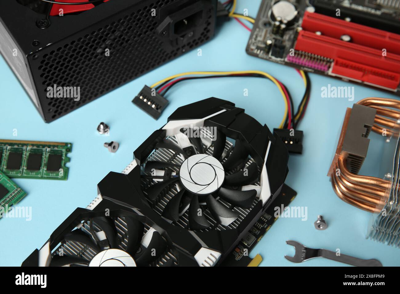 Graphics card and other computer hardware on light blue background ...