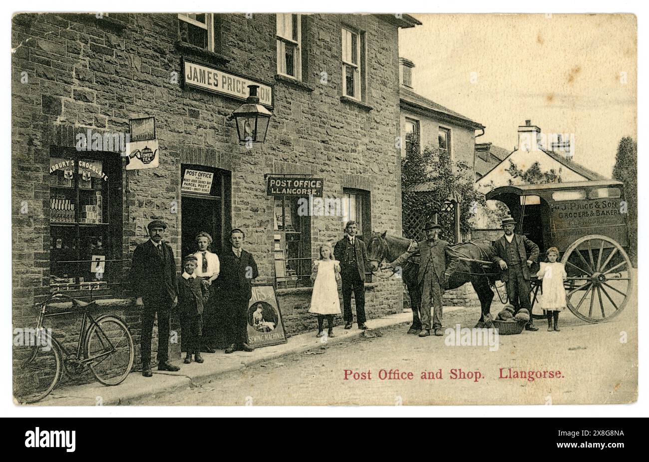 Original early 1900's postcard of Llangorse post office and shop, James Price owned this shop as well as the bakers and grocers  delivery cart, and the photograph itself was by James Price & Son, From the village of Llangorse, Powys, near Brecon, Wales, U.K. Victorian shop /  Edwardian Shop. Victorian post office.The photo is dated from around 1910 by the fashions, but posted 4 Aug 1915 Stock Photo