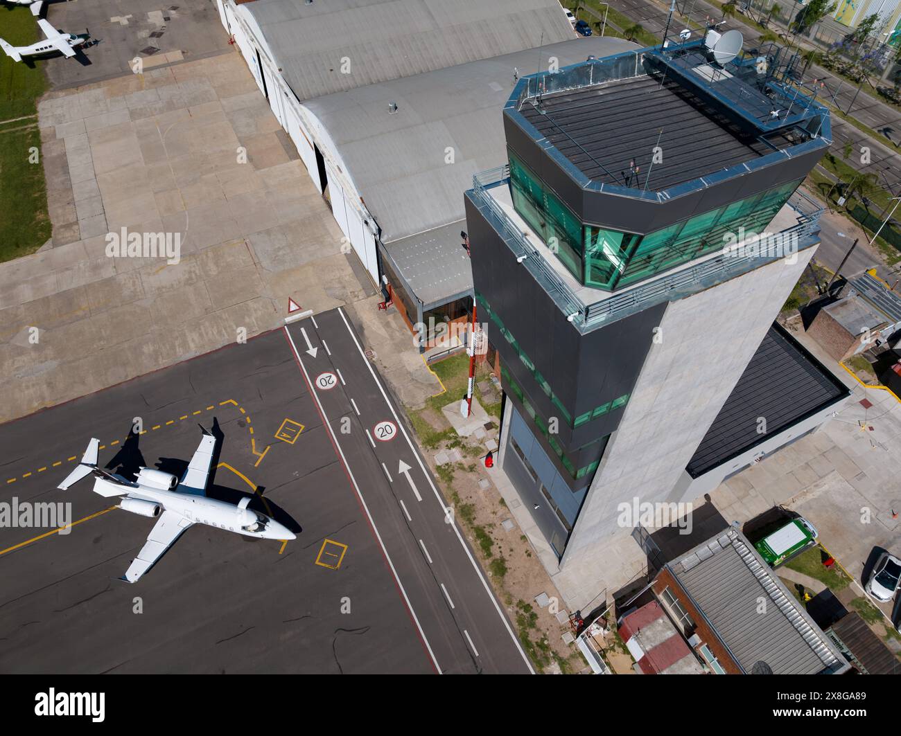 Control Tower 2 Aerial view of an airport with planes parked on the runway next to the ...