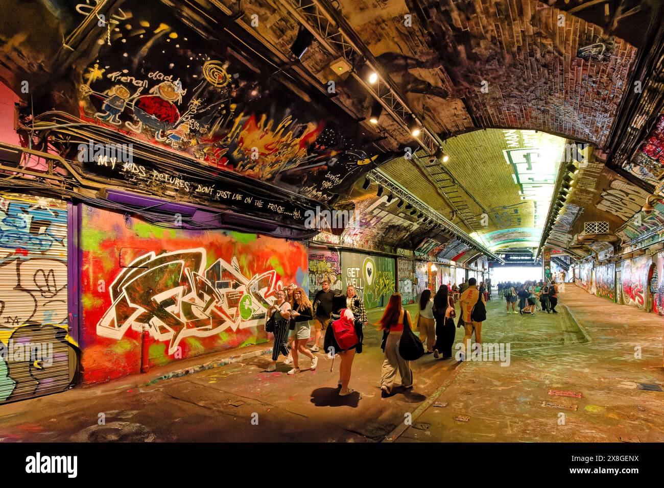 London Leake Street The Graffiti Tunnel many tourists inside the colourful dark tunnel Stock Photo