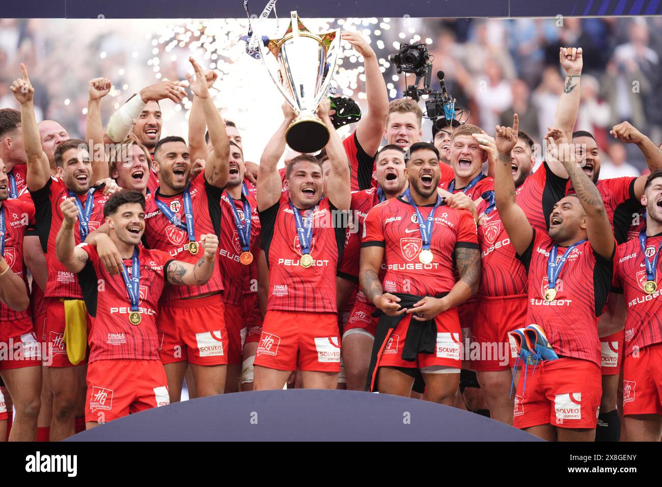 Stade Toulousain players lift the trophy following the Investec