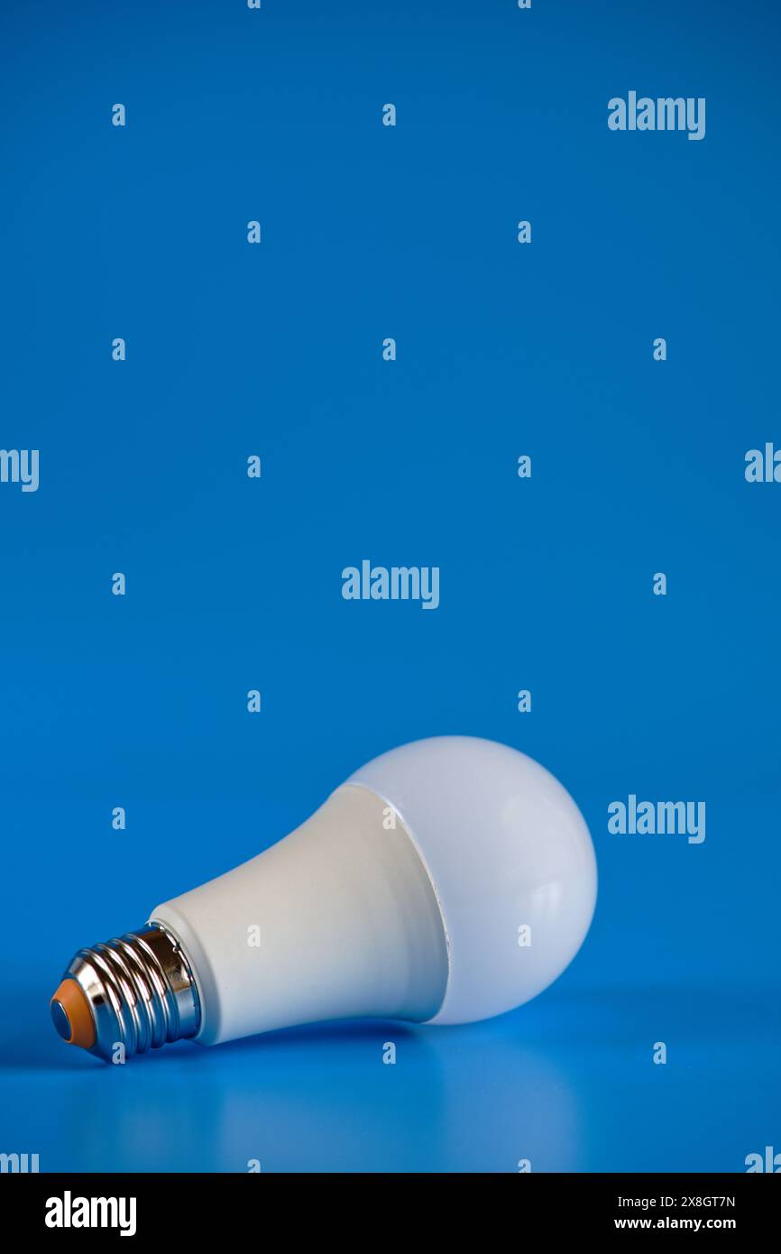 Energy-saving LED light bulb on a blue background Stock Photo