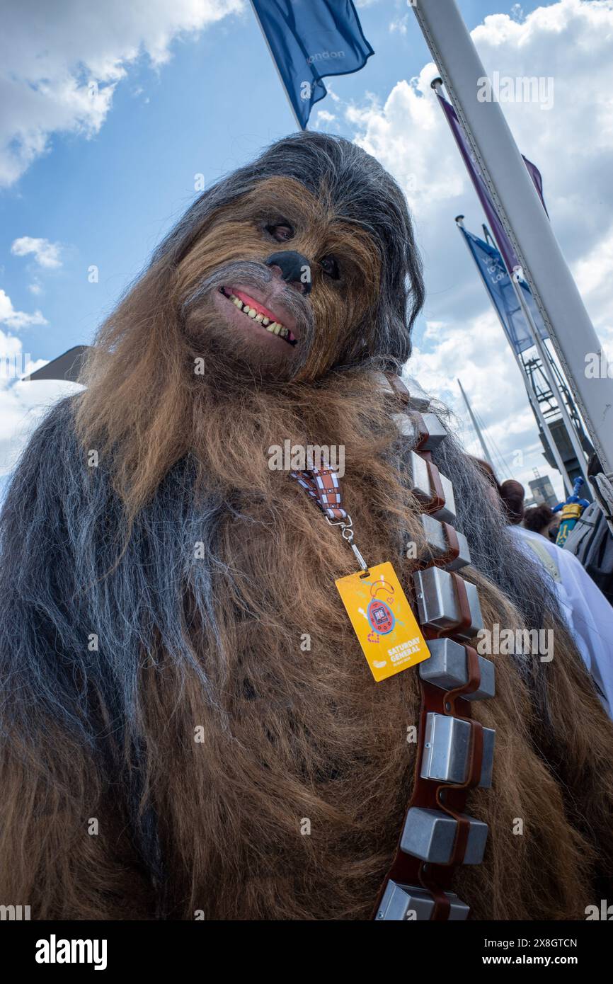 London, UK, 25th May, 2024. A visitor to day two of Comic Con London poses in a Chewbacca outfit outside the venue. Credit: James Willoughby/17�Թ����� Live News Stock Photo