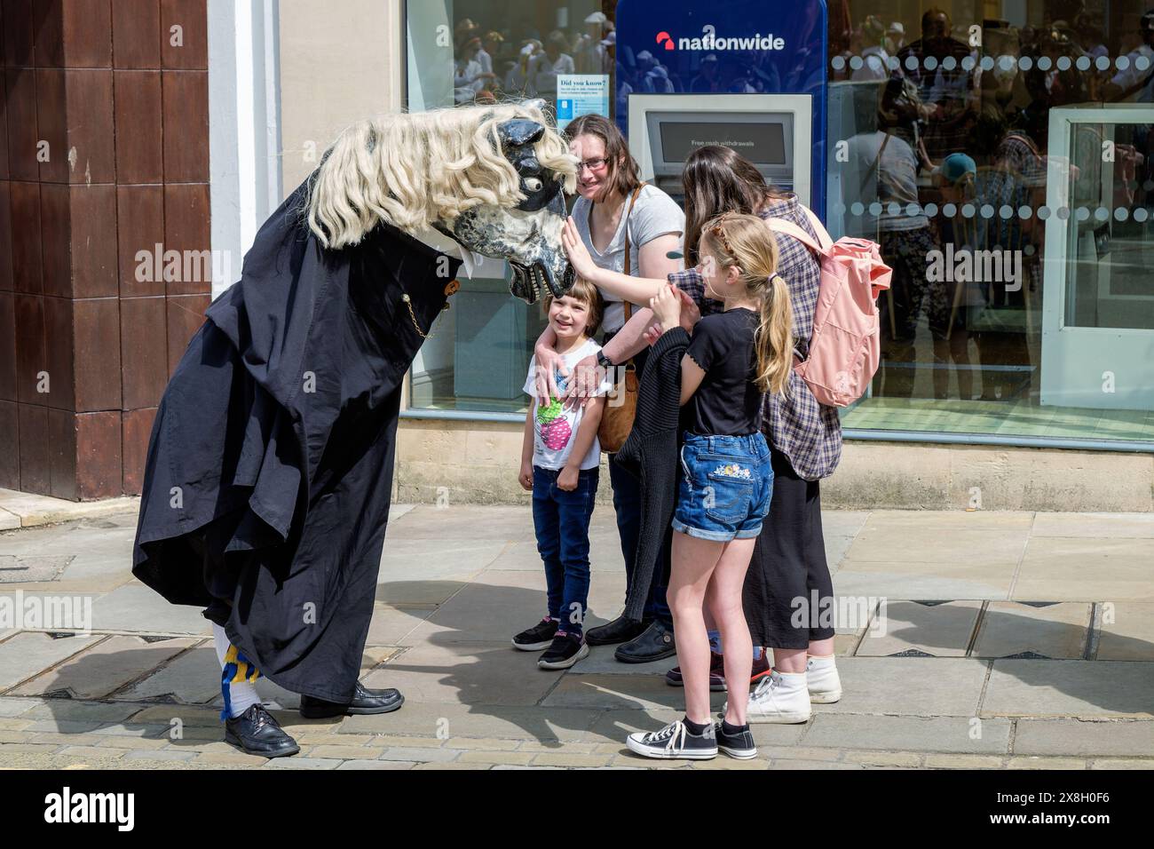 Chippenham, Wiltshire, UK, 25th May, 2024. The Yateley Morris Men's hobby horse is pictured meeting members of the public on the opening day of the 2024 Chippenham folk festival. Credit: Lynchpics/Alamy Live News Stock Photo