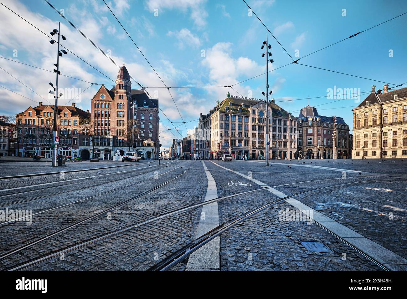 Netherlands, Amsterdam - April 7, 2024: Morning view on the central Dam square in the city of Amsterdam is the busiest place of the city for tourists Stock Photo
