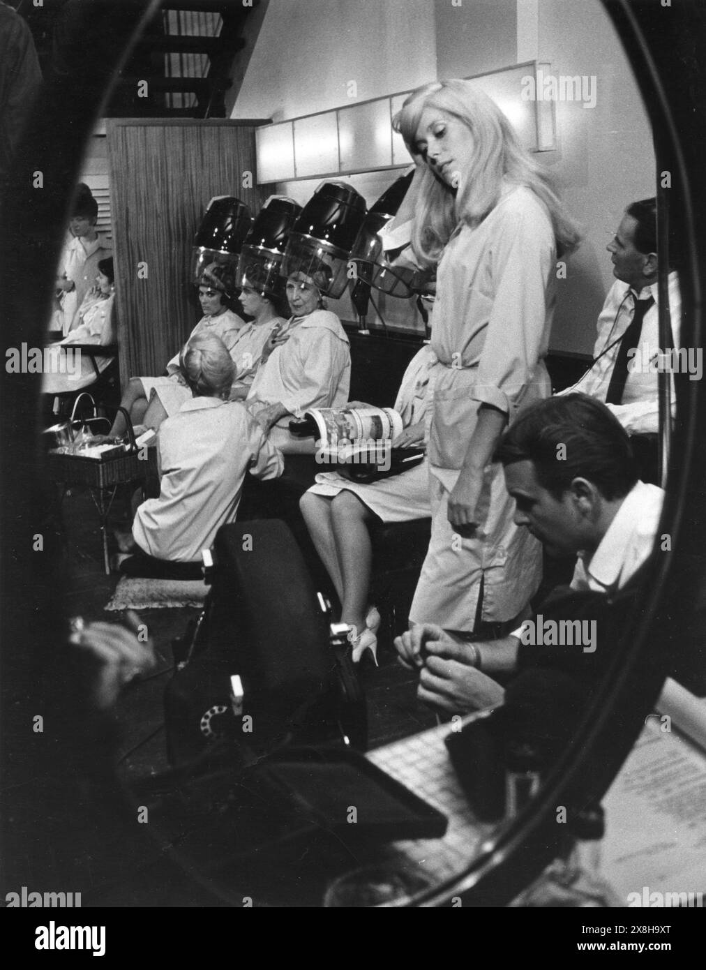 French actress CATHERINE DENEUVE filming a scene in Vidal Sassoon's