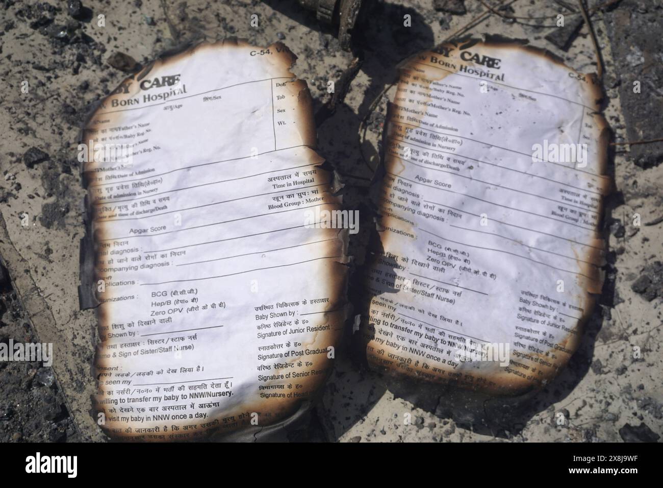 Burnt registration cards lie on the floor of a baby care center in New Delhi, India, Sunday, May 26, 2024. A fire broke out in the care center on Saturday night killing six infants, a fire service officer said on Sunday. (AP Photo/Dinesh Joshi) Stock Photo