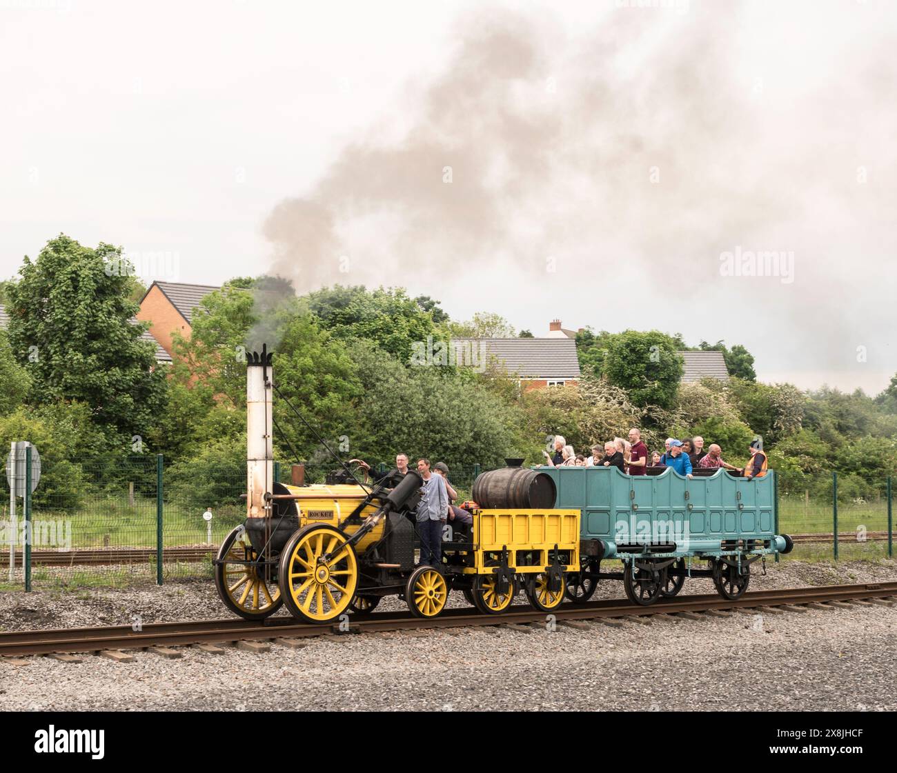 Replica Of Stephensons Rocket With A Coach Of Visitors At Locomotion