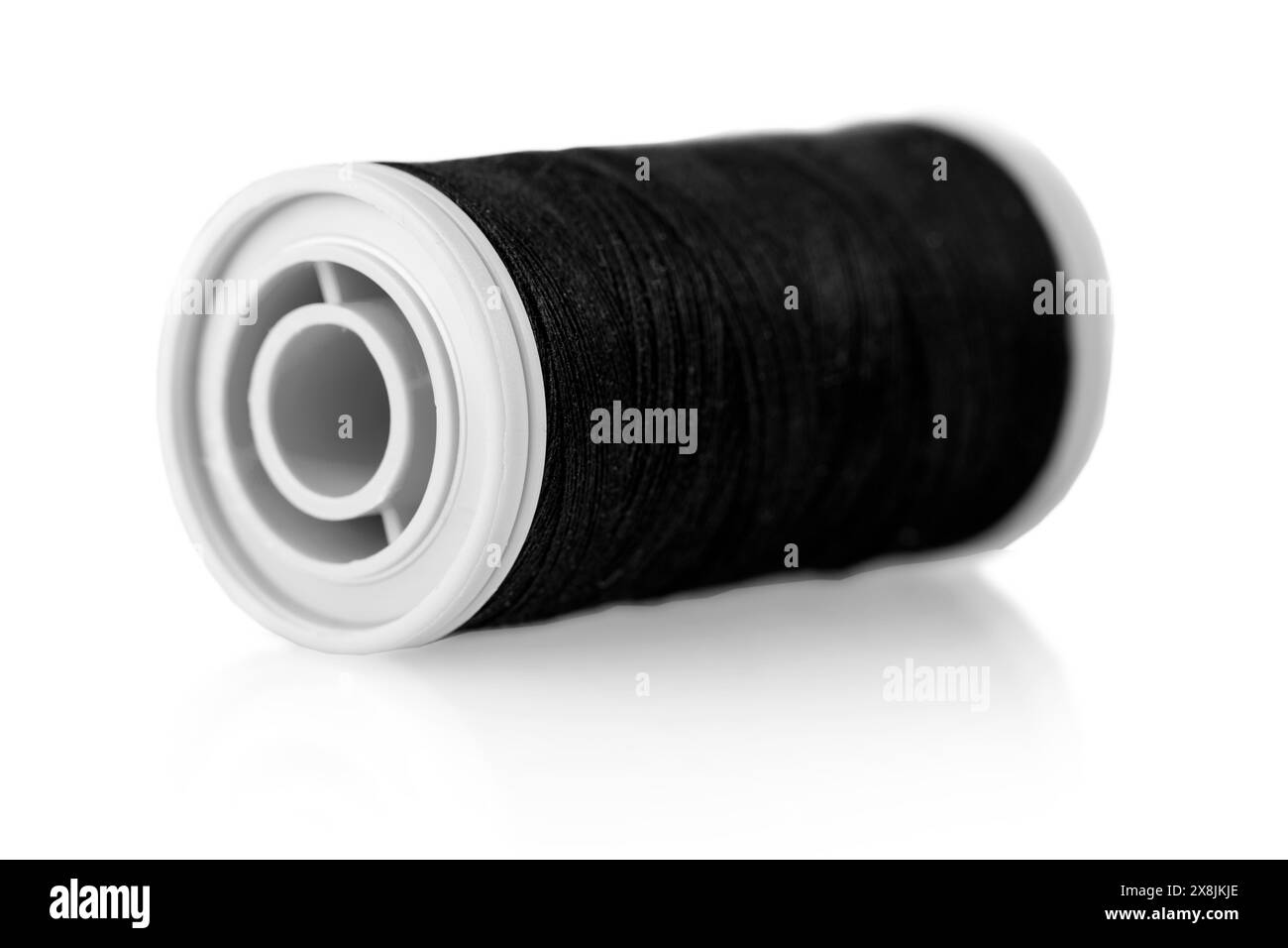 bobbin with black thread on a white background Stock Photo - Alamy