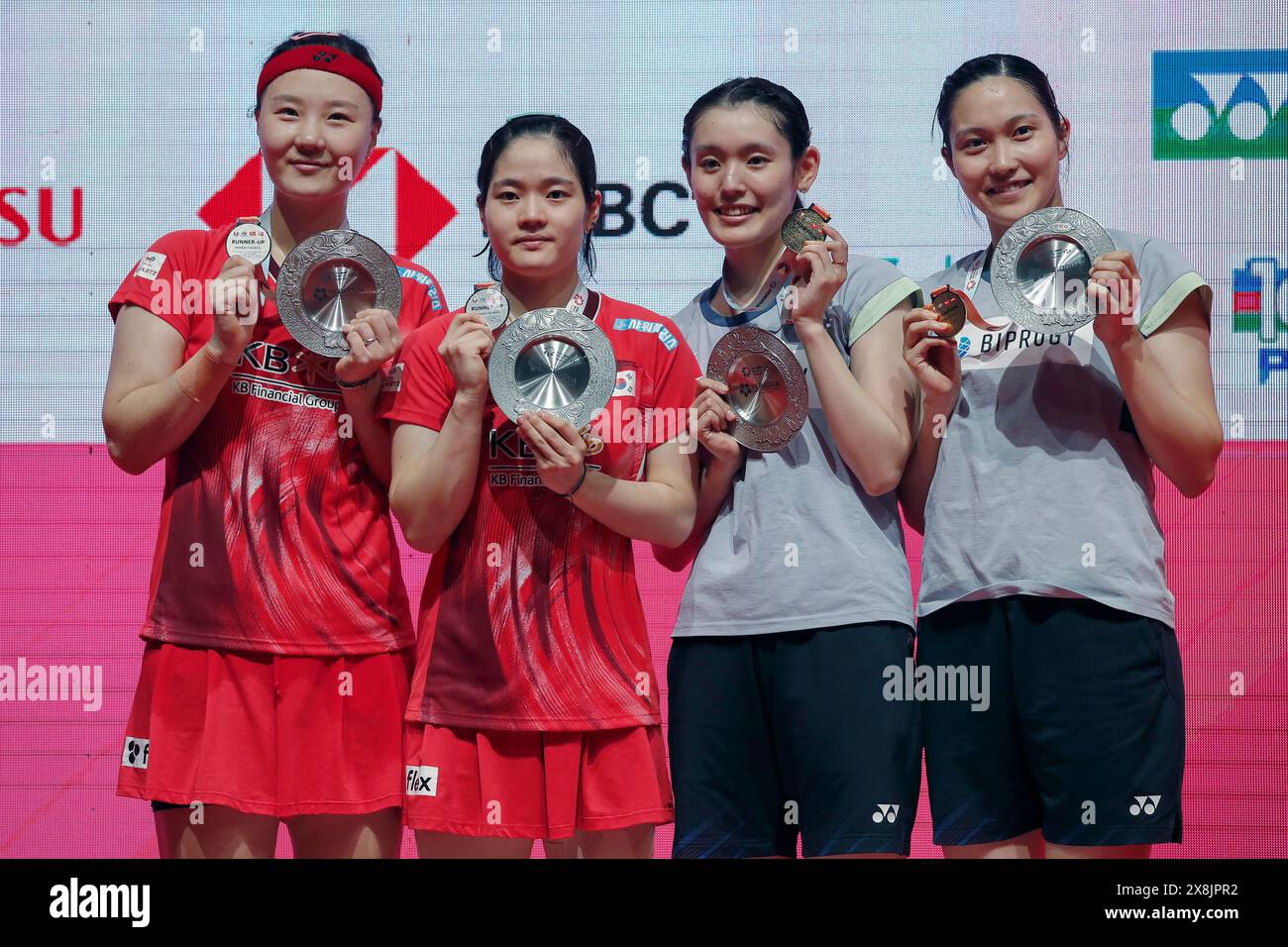 Kuala Lumpur, Malaysia. 26th May, 2024. (L-R) Shin Seung Chan and Lee Yu Lim of Korea, Rin Iwanaga and Kie Nakanishi of Japan pose for photos with their medals at the victory ceremony after the Women's Doubles Final match of the Perodua Malaysia Masters 2024 at Axiata Arena. Rin Iwanaga and Kie Nakanishi won with scores; 17/21/21 : 21/19/18. Credit: SOPA Images Limited/Alamy Live News Stock Photo