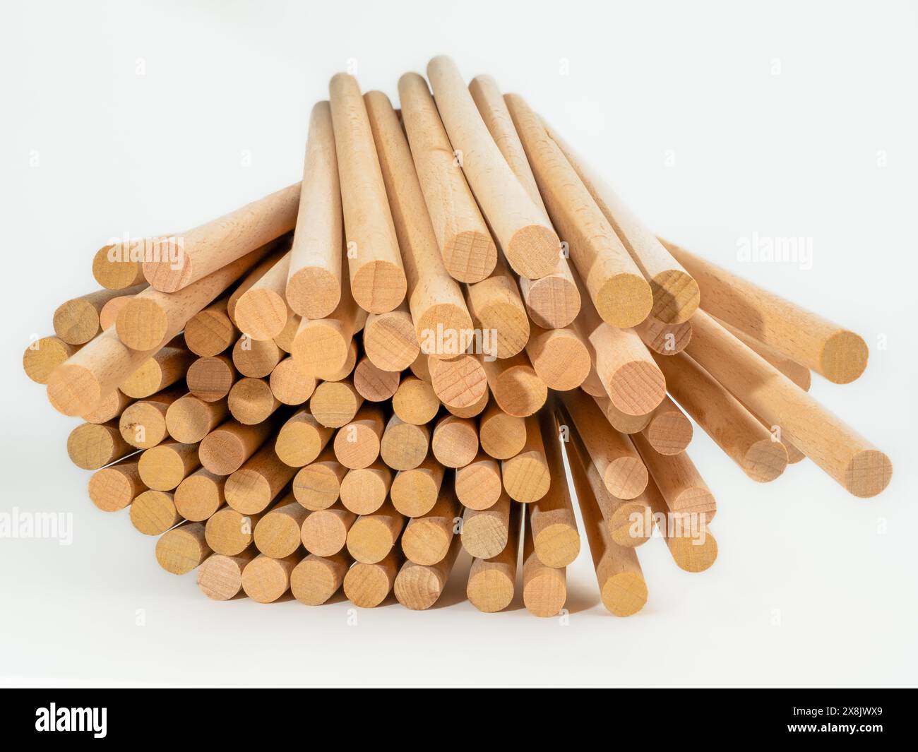 stack of hardwood dowel rods pins for crafting and woodworking Stock Photo