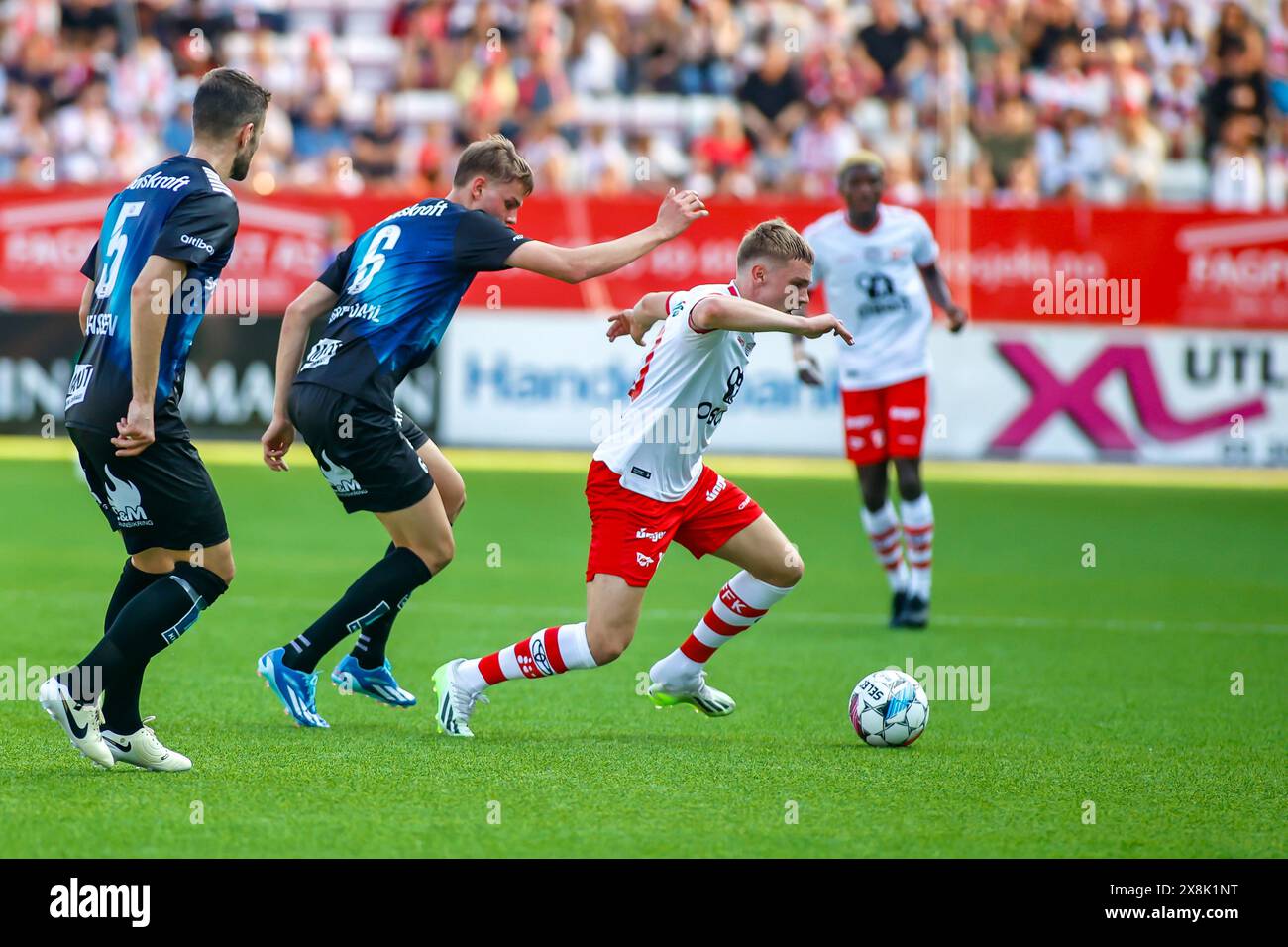 Fredrikstad, Norway, 25th May 2024.  Fredrikstad's Jeppe Kjær is tripped by Tromsø's Jens Hjertø-Dahl in the Eliteserien match between Fredrikstad and Tromsø at Fredrikstad stadium.  Credit: Frode Arnesen/Alamy Live News Stock Photo
