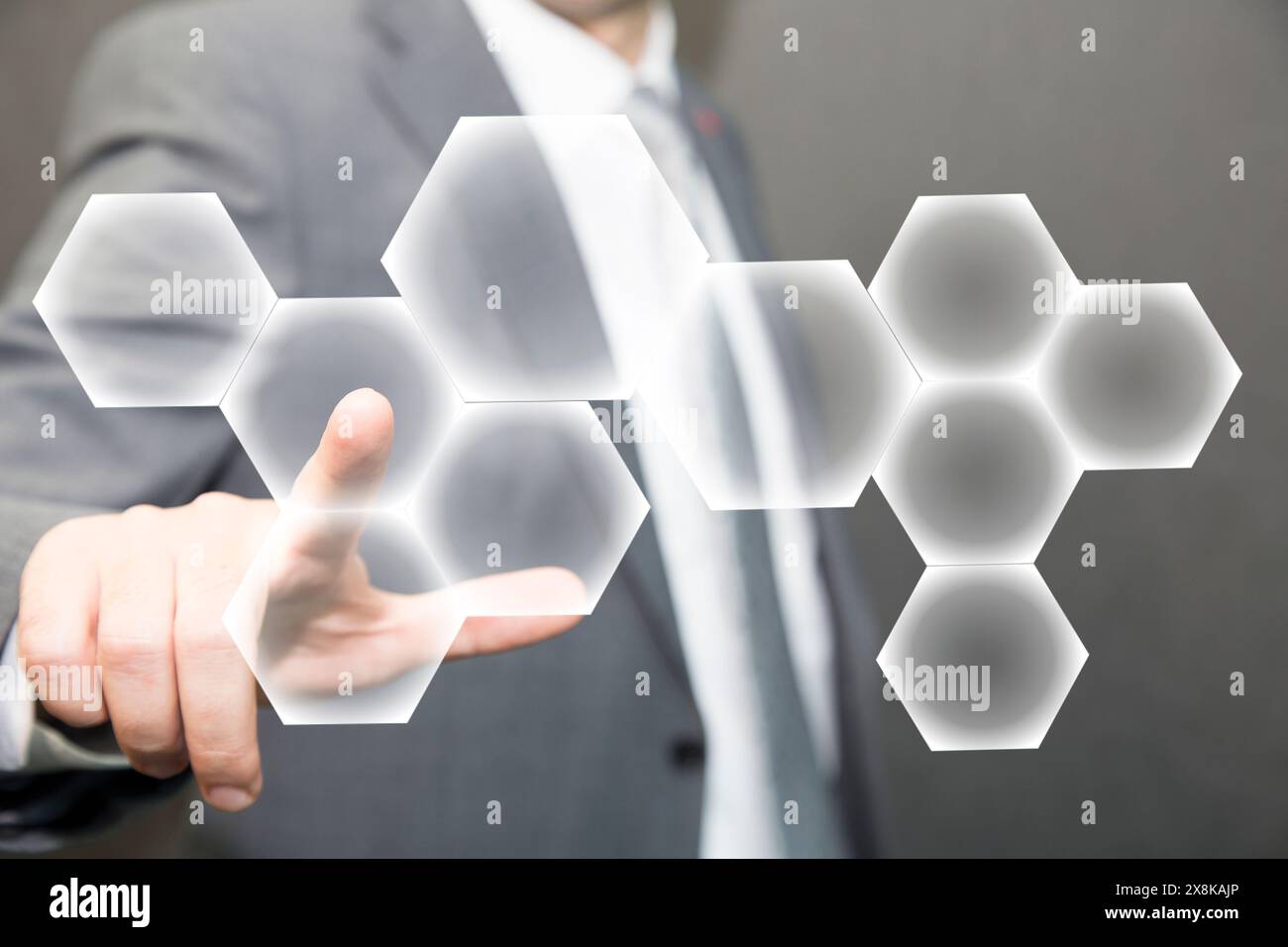 Person touching an hexagonal button on a digital interface. Concept about technology and choices Stock Photo