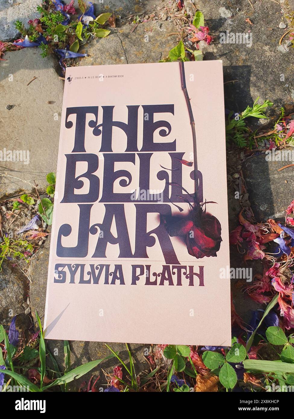 The Bell Jar Novel by Sylvia Plath Book in a Garden Scenery Stock Photo