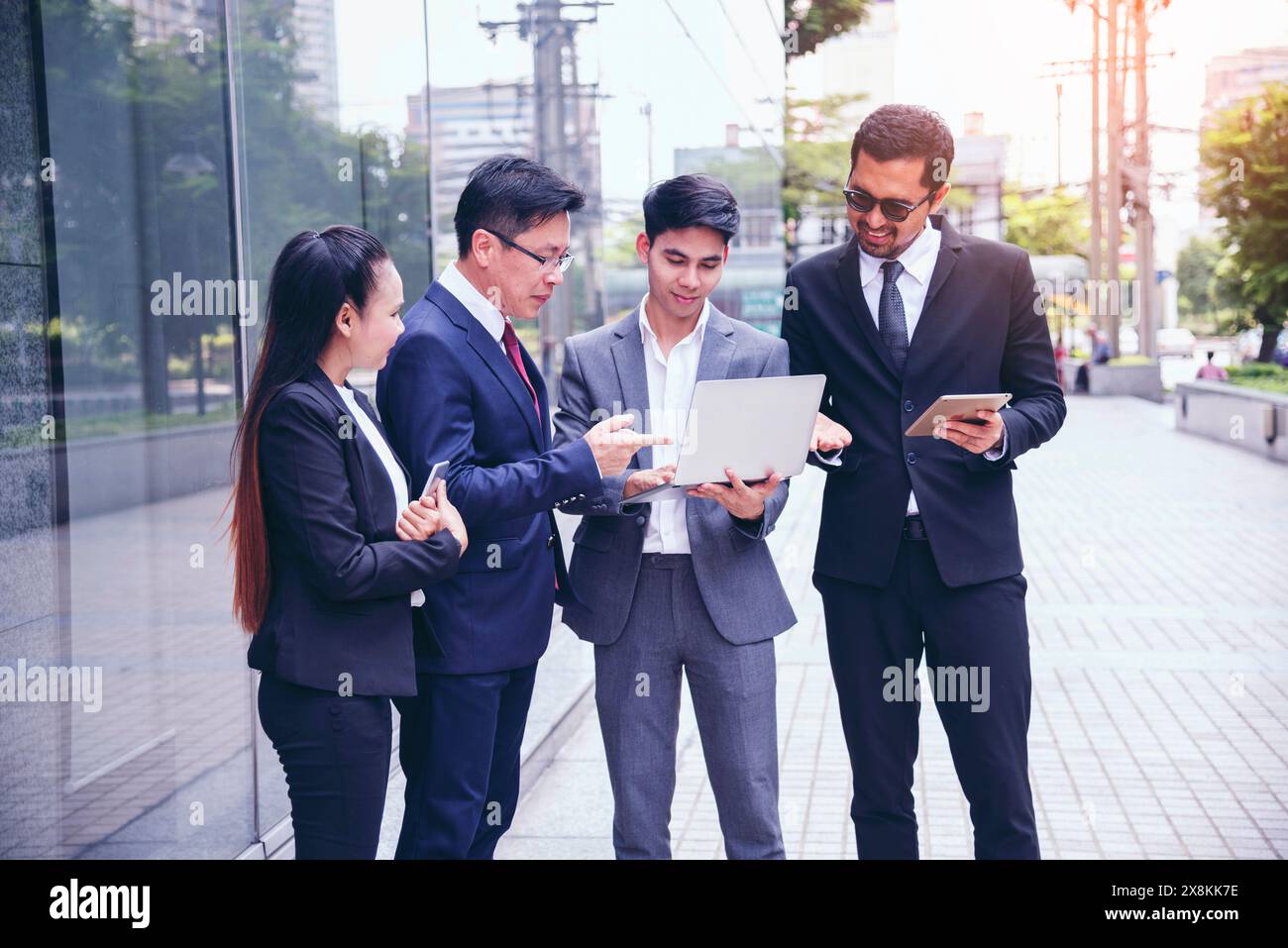 Asian diversity multicultural business corporate people group outdoor in modern city. Diversity coworkers team talking trust in partnership. Consultan Stock Photo