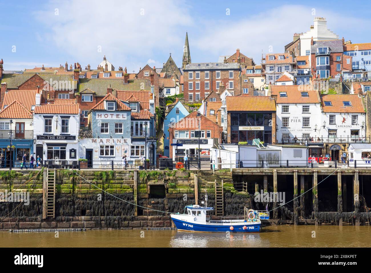 Whitby Yorkshire Whitby Harbour with small fishing boat in the harbour and the quayside fish market Whitby North Yorkshire England UK GB Europe Stock Photo