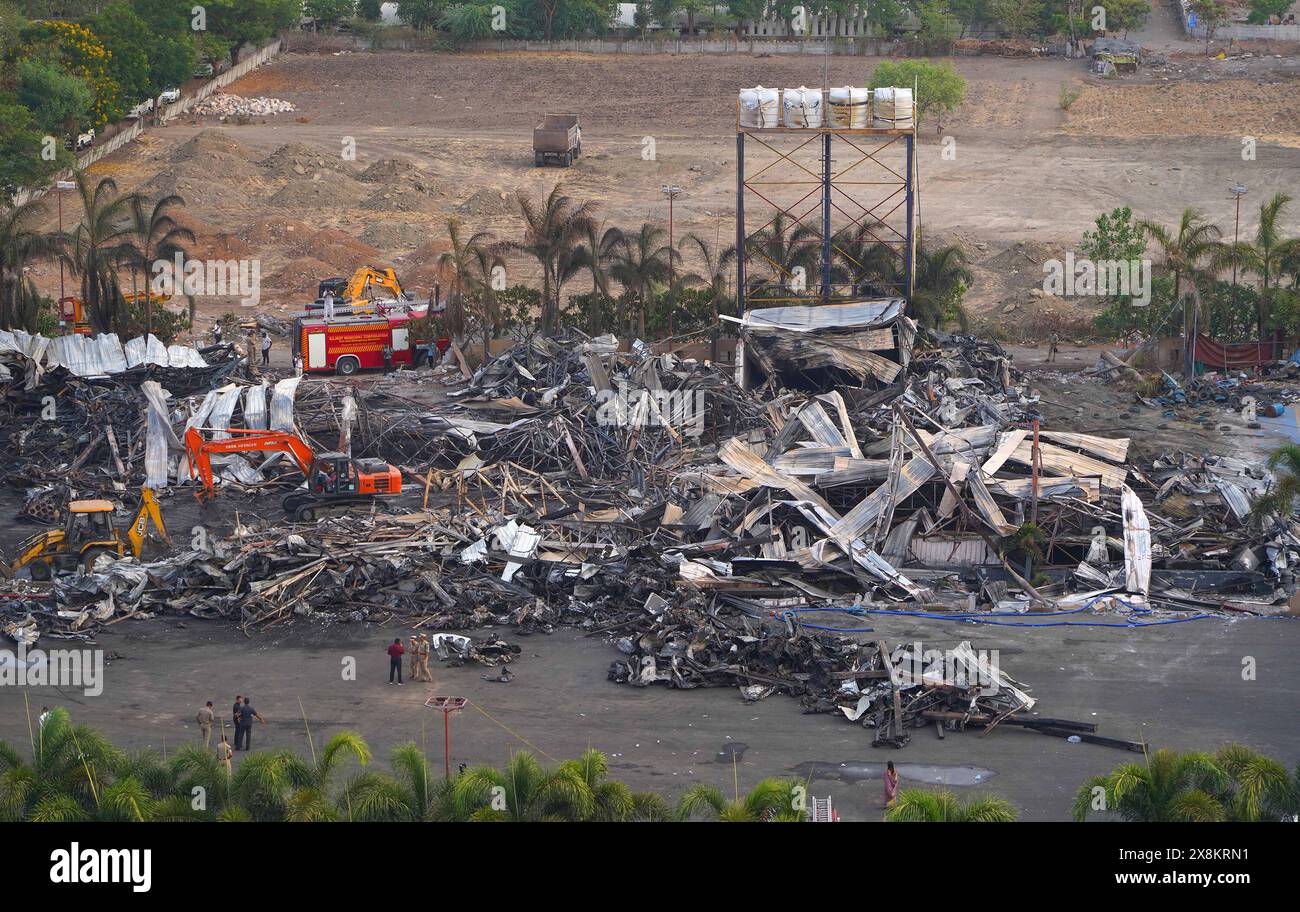 Rajkot. 26th May, 2024. Machines remove burnt debris after a fire broke out in an entertainment park at Rajkot district of India's western state of Gujarat, May 26, 2024. The death toll in Saturday's fire in India's western state of Gujarat has risen to 28 from 24, a local fire department official said on Sunday. Credit: Str/Xinhua/Alamy Live News Stock Photo