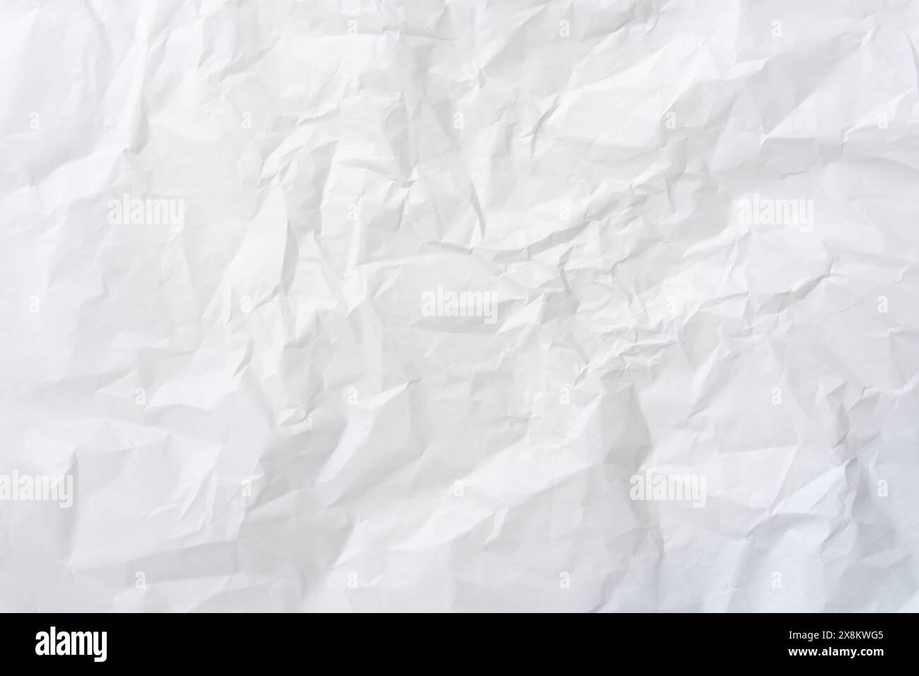 Wrinkled or crumpled white stencil or tissue paper texture is used for crumpled paper background texture. Stock Photo