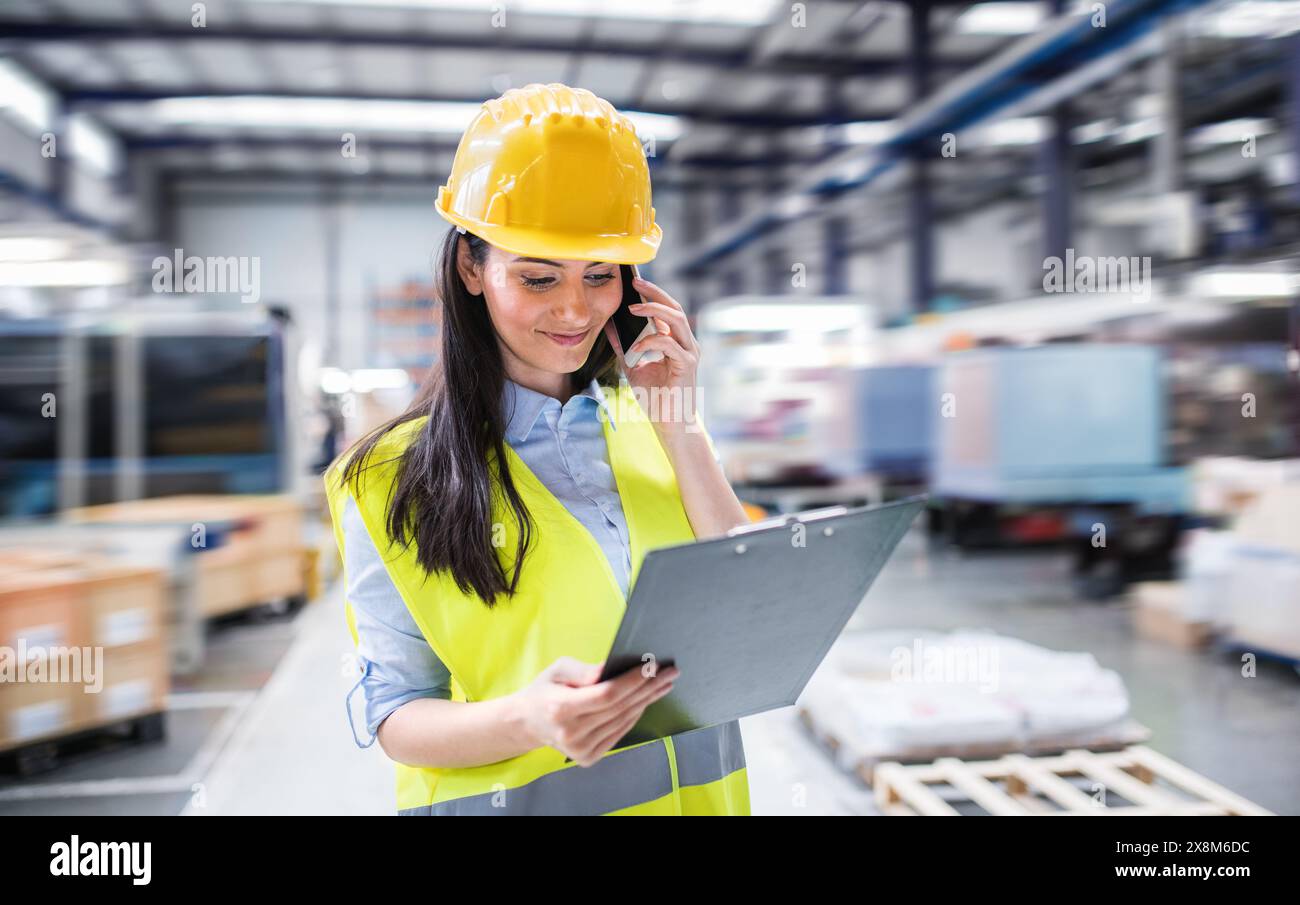 Manager woman in business casual clothes controlling goods in warehouse  Stock Photo - Alamy