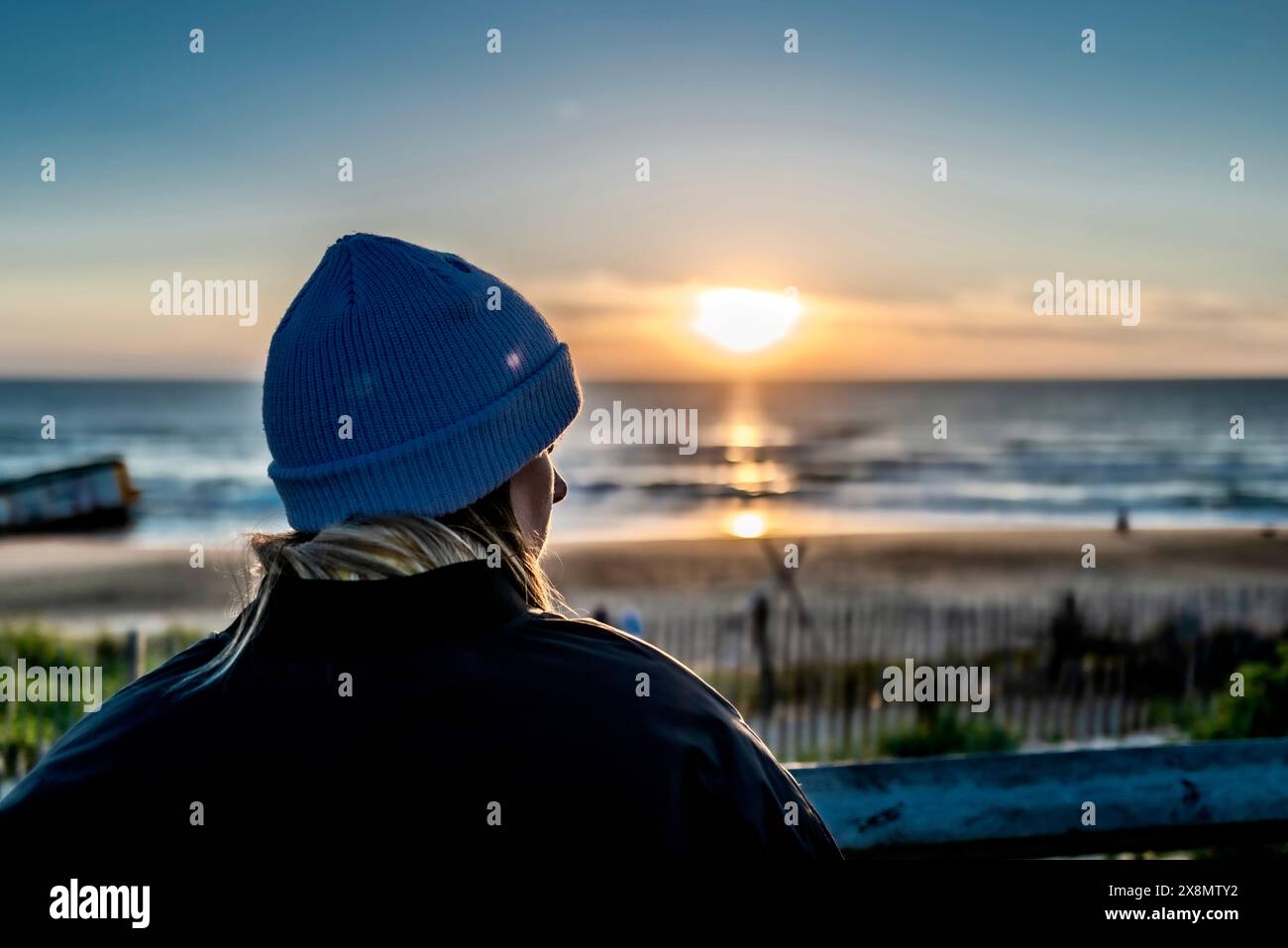 Woman watching sunset at beach hi-res stock photography and images - Alamy