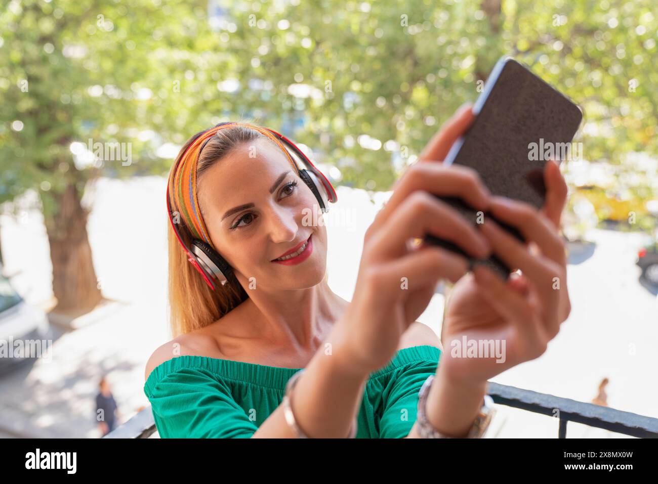 A woman is taking a selfie with her cell phone Stock Photo