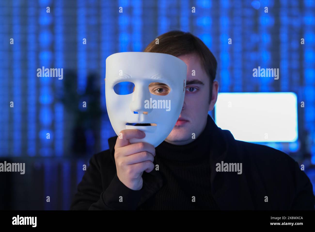 Hacker with mask in dark room, closeup Stock Photo