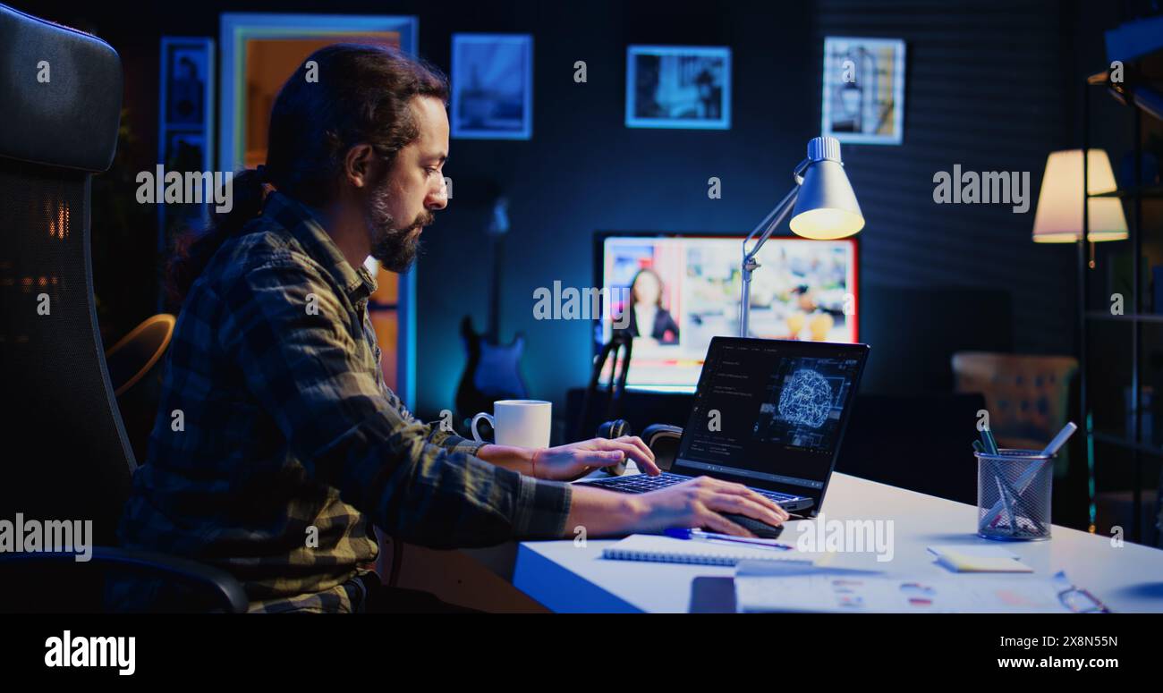 Data scientist updating artificial intelligence neural networks, writing complex binary code scripts. Teleworking freelancer in apartment office uses digital device programming to upgrade AI, camera B Stock Photo