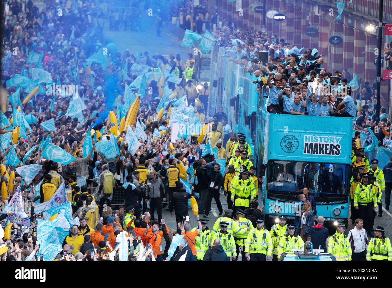 Manchester, UK. 26th May, 2024. Phil Foden with the Premiership trophy next to Erling Haaland on the open top bus. Manchester City victory parade moves along Deansgate in the city centre. Fans lined the route  in the city centre to watch the parade to celebrate their club's historic Premier League title triumph. Manchester City became the first team in the history of English football to win four back-to-back league titles thanks to a 3-1 victory over West Ham United last Sunday (May 19). Manchester UK Picture: garyroberts/worldwidefeatures.com Credit: GaryRobertsphotography/Alamy Live News Stock Photo