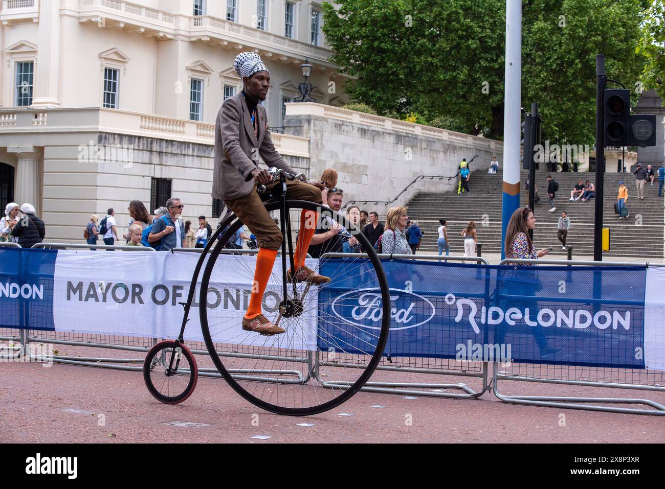London, UK. 26th May, 2024. A cyclist rides his high wheel bicycle also ...