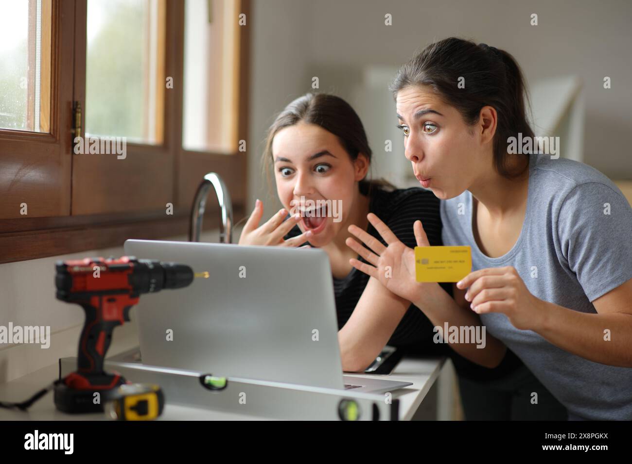 Two Excited Women Reforming House Buying Online With Laptop And Credit