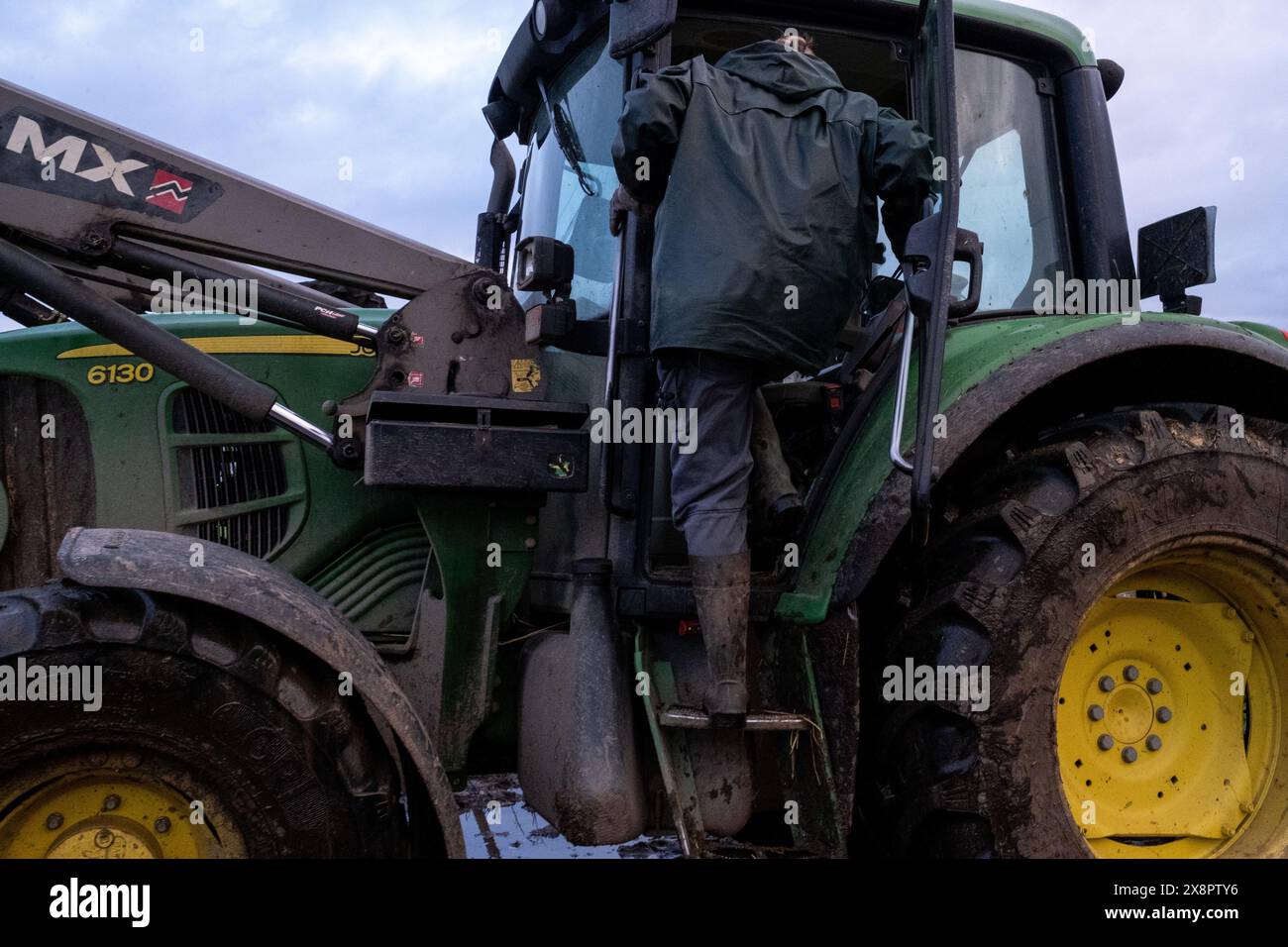 Adeline, a farmer, climbs into her tractor on her farm in Cotes-d Armor ...