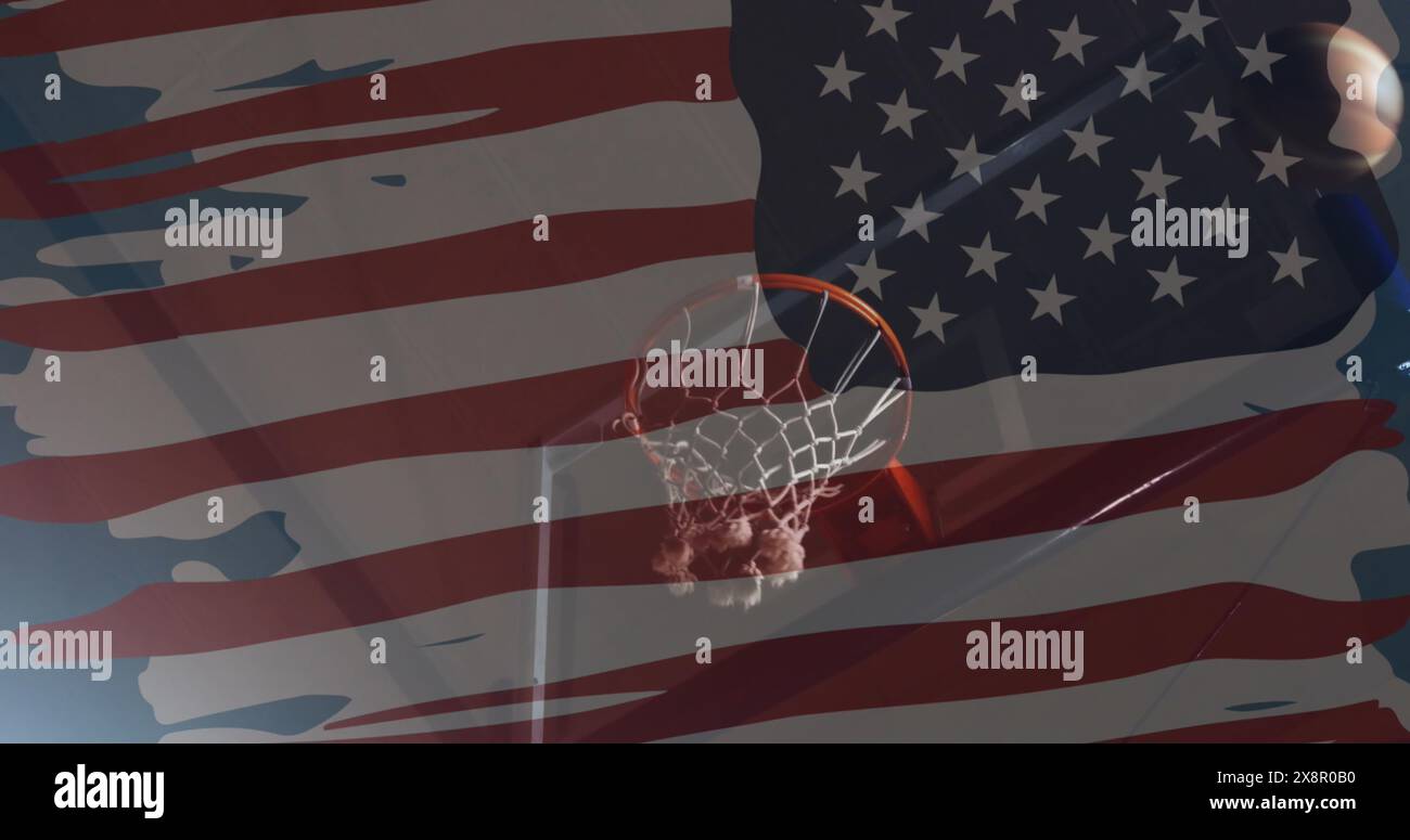 Image of flag of america over hand of caucasian male basketball player taking a shot Stock Photo