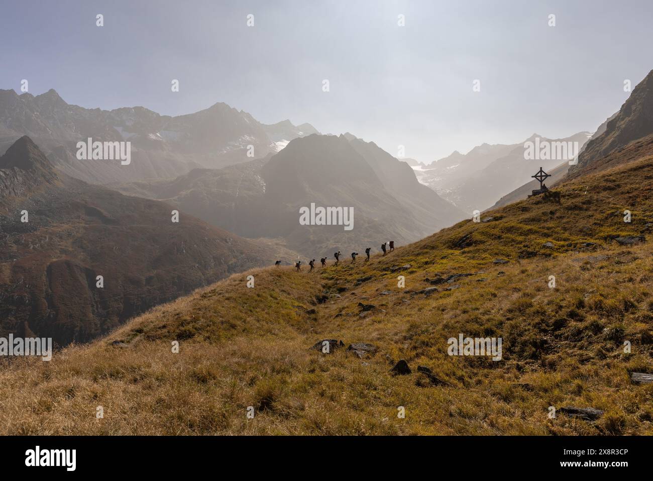 Hikers in Tyrol's Stub Alps with a stunning mountain backdrop Stock Photo