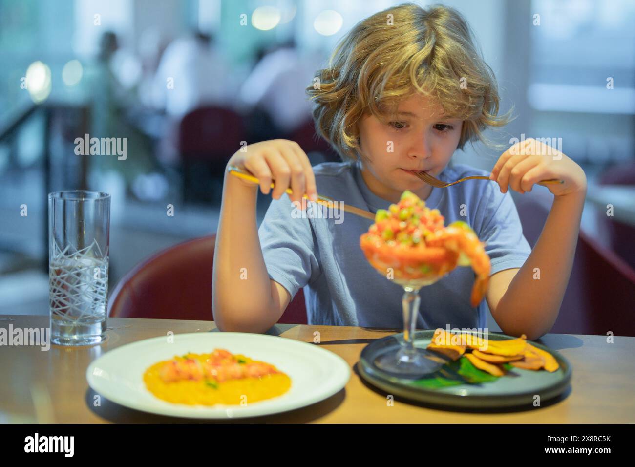 Little boy eating seafood in restaurant. Kid eat Food fish gourmet ...