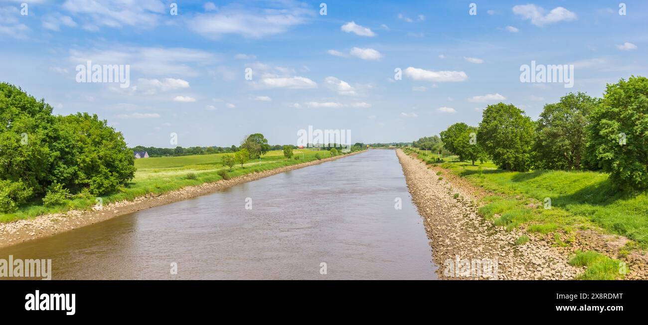 Panorama of the river Ems going through the landscape in spring near Papenburg, Germany Stock Photo