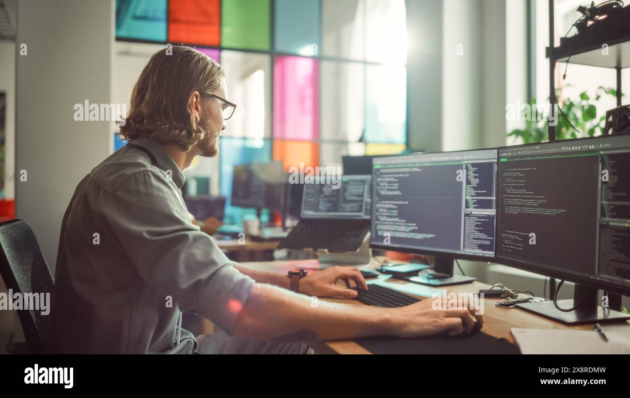 Professional Male Programmer Writing Code on Desktop Computer With ...