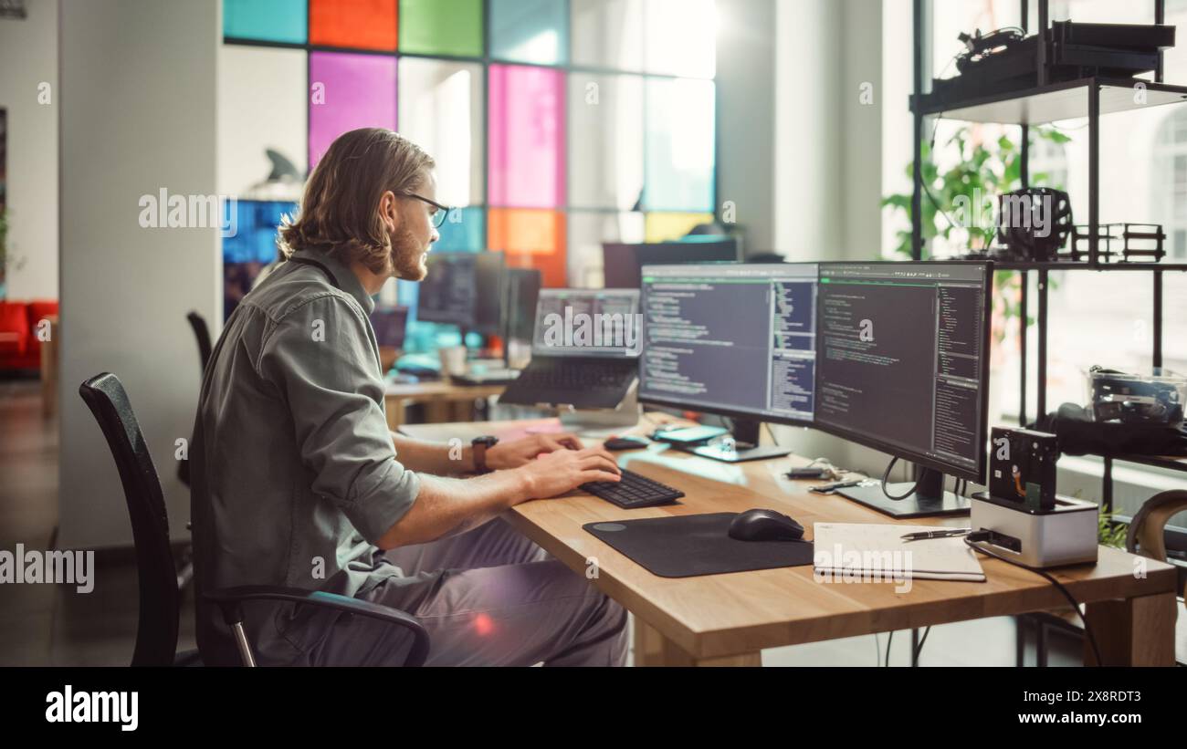 Professional Male Programmer Writing Code on Desktop Computer With ...