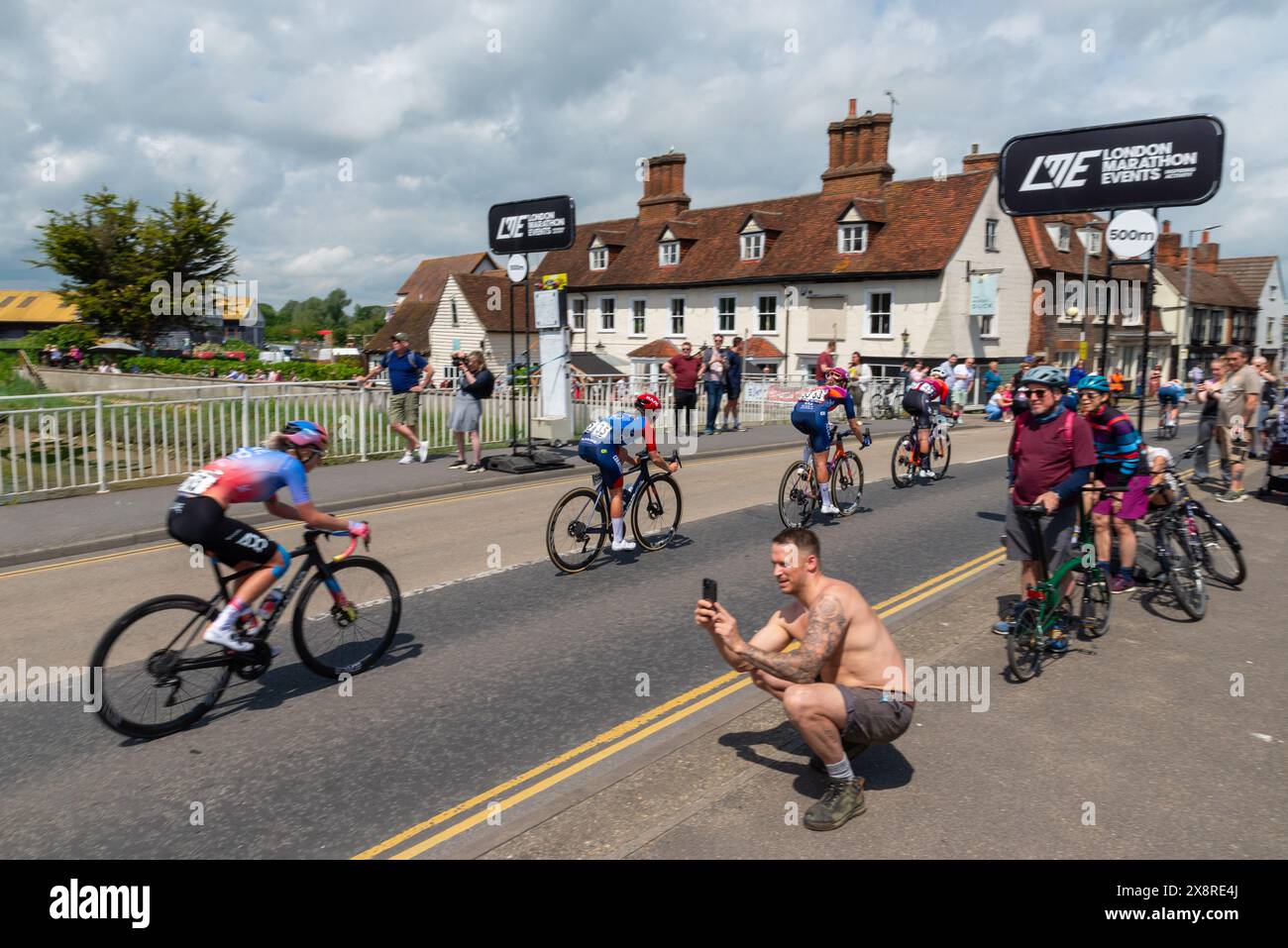 2024 RideLondon Classique Women's WorldTour cycle race Stage Two in Maldon, Essex, UK. Cyclists racing across Fullbridge by the Muddy Duck pub Stock Photo