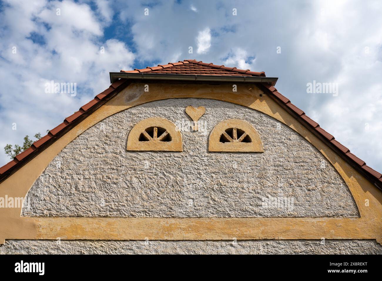 Detail of a gable 'Špitál' (Infirmary) building in Kadov, Czechia. Example of simple architectural decoration in rustic baroque style. Stock Photo