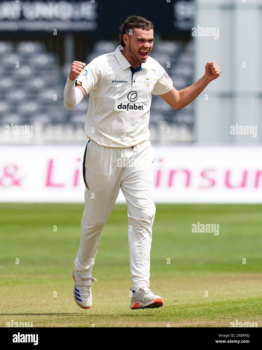 Bristol, UK, 27 May 2024. Derbyshire's Sam Conners celebrates taking the wicket of Gloucestershire's Graeme van Buuren during the Vitality County Championship match between Gloucestershire and Derbyshire. Credit: Robbie Stephenson/Gloucestershire Cricket/Alamy Live News Stock Photo