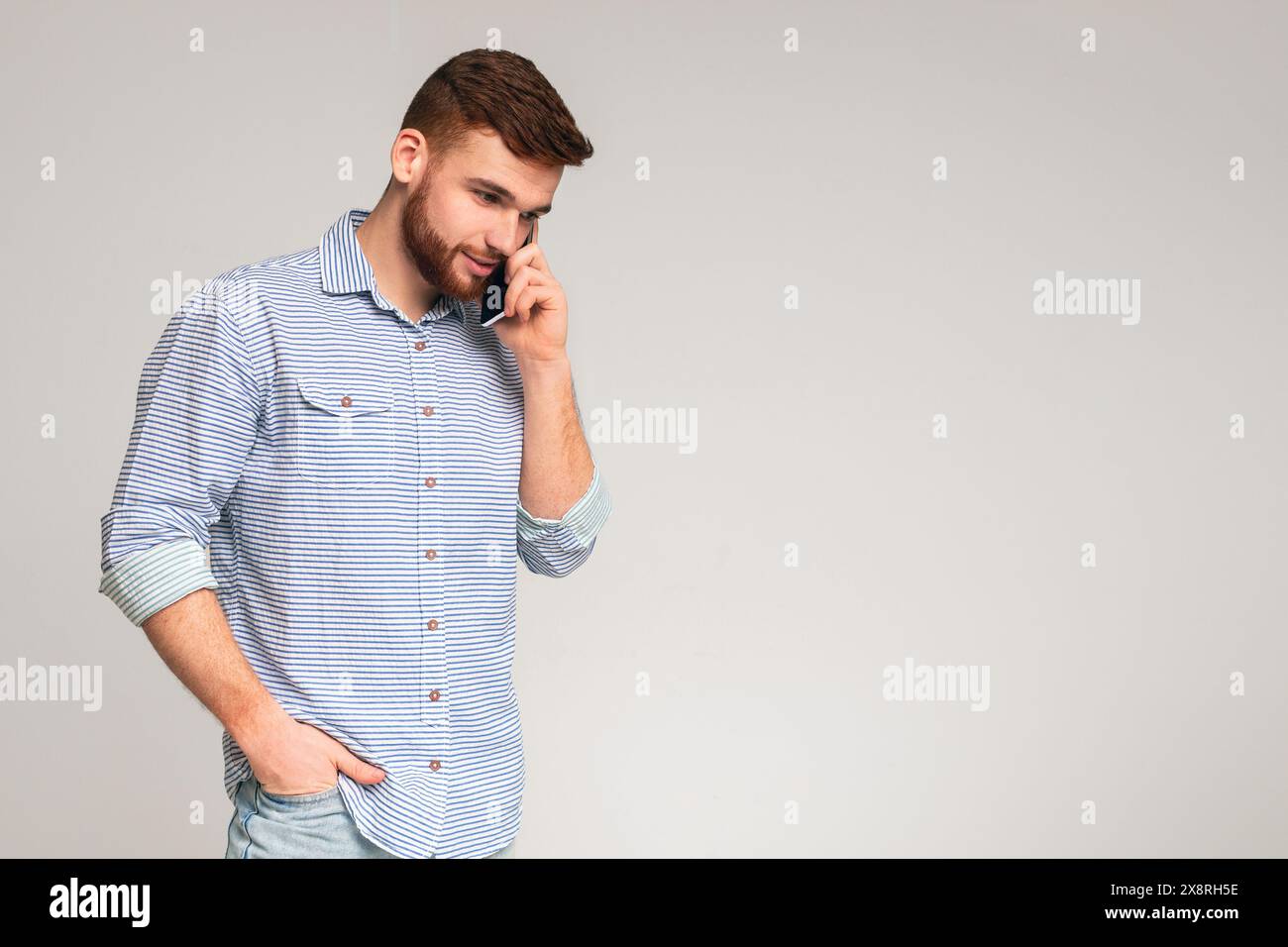 Handsome man talking on cellphone and smiling Stock Photo