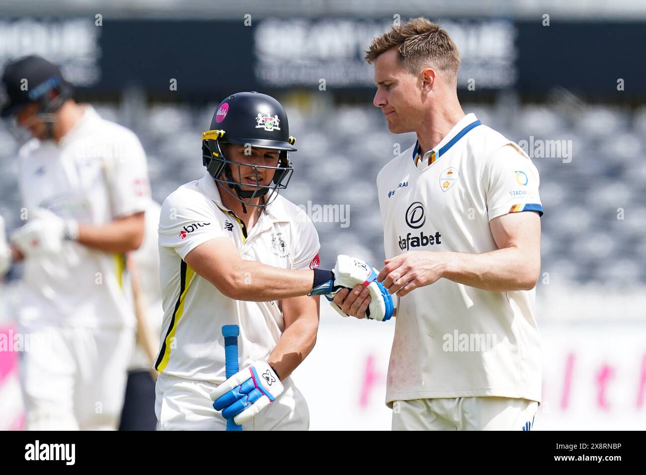 Bristol, UK, 27 May 2024. Gloucestershire's Graeme van Buuren shakes hands with Derbyshire's Luis Reece during the Vitality County Championship match between Gloucestershire and Derbyshire. Credit: Robbie Stephenson/Gloucestershire Cricket/Alamy Live News Stock Photo