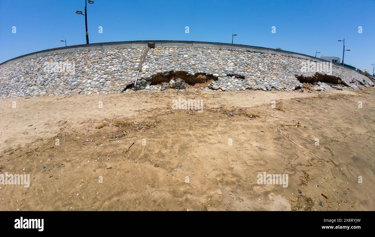 Photography of eroded stone wall near a beach and sea in Oman Muscat during spring sunny day Stock Photo