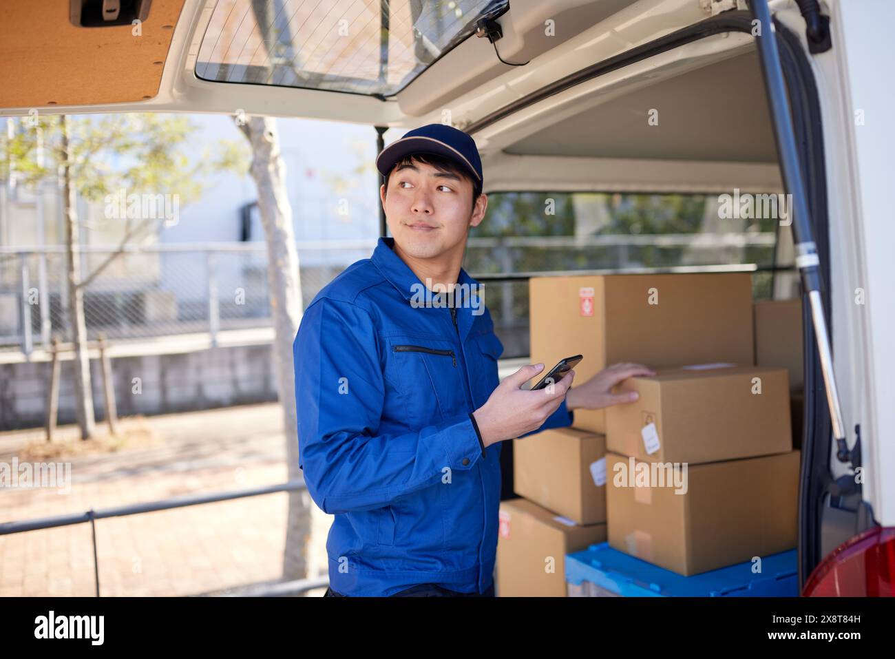 Japanese delivery man checking boxes in the car Stock Photo - Alamy
