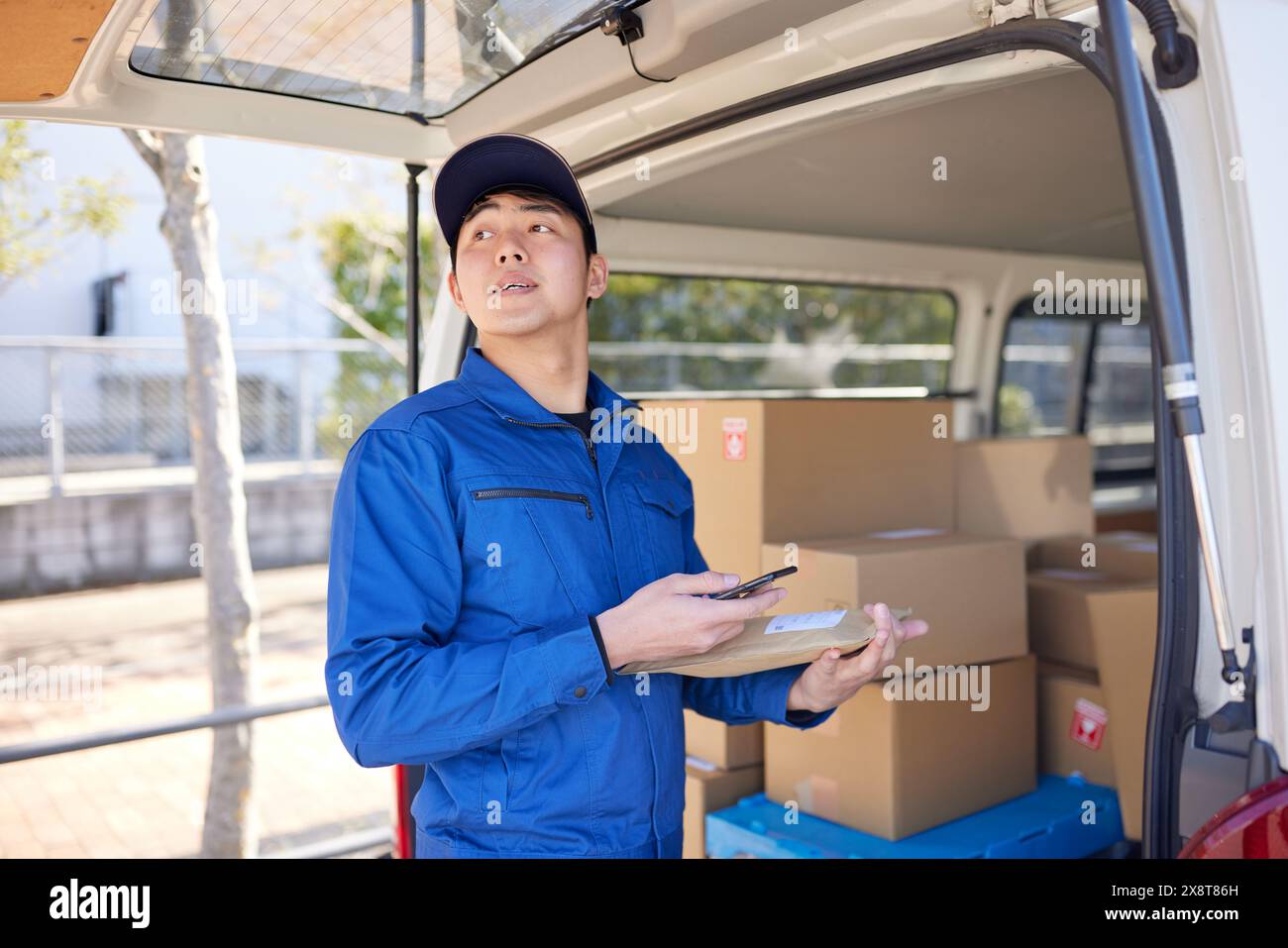 Japanese delivery man checking boxes in the car Stock Photo - Alamy