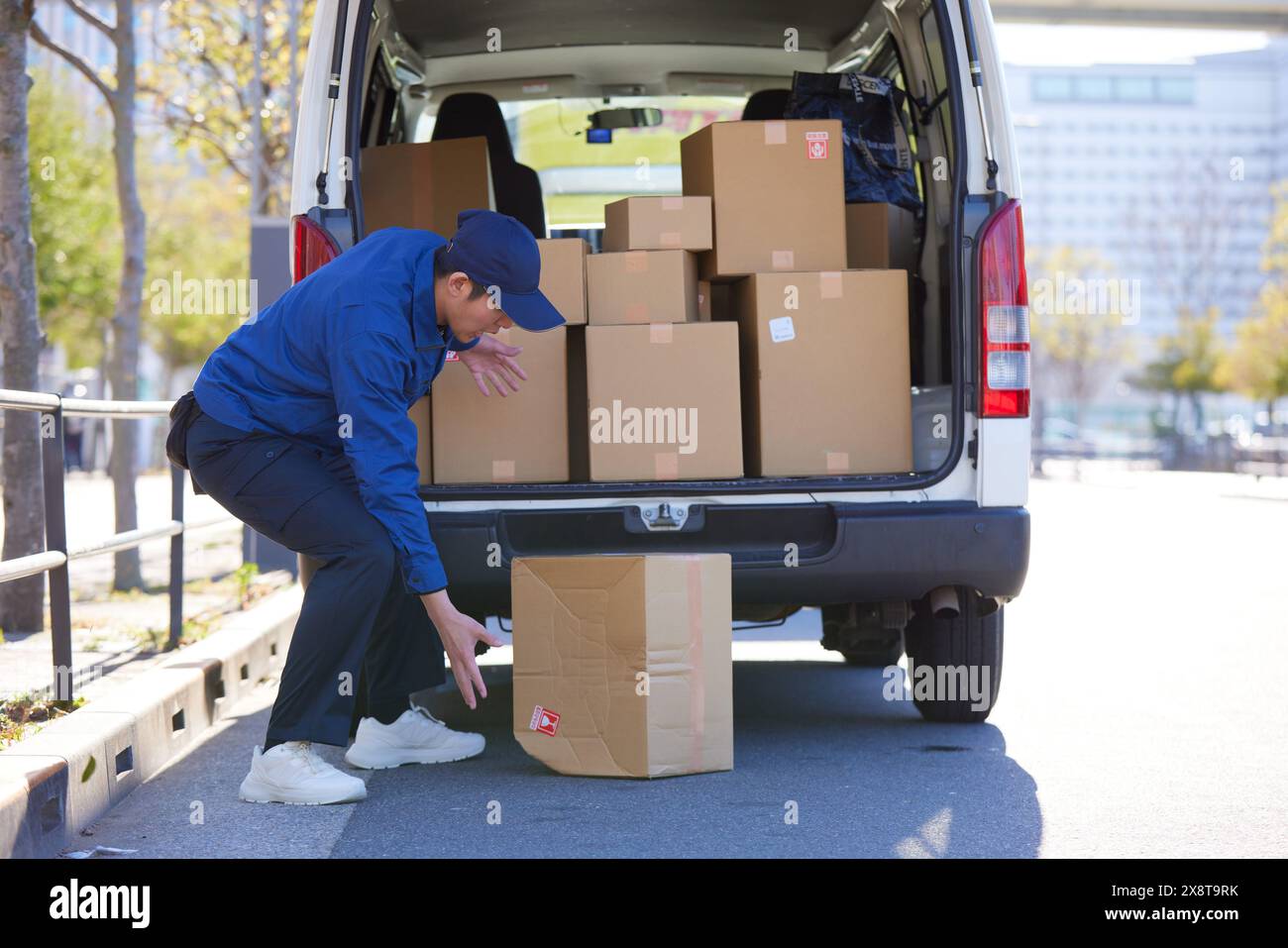 Japanese delivery man checking boxes in the car Stock Photo - Alamy