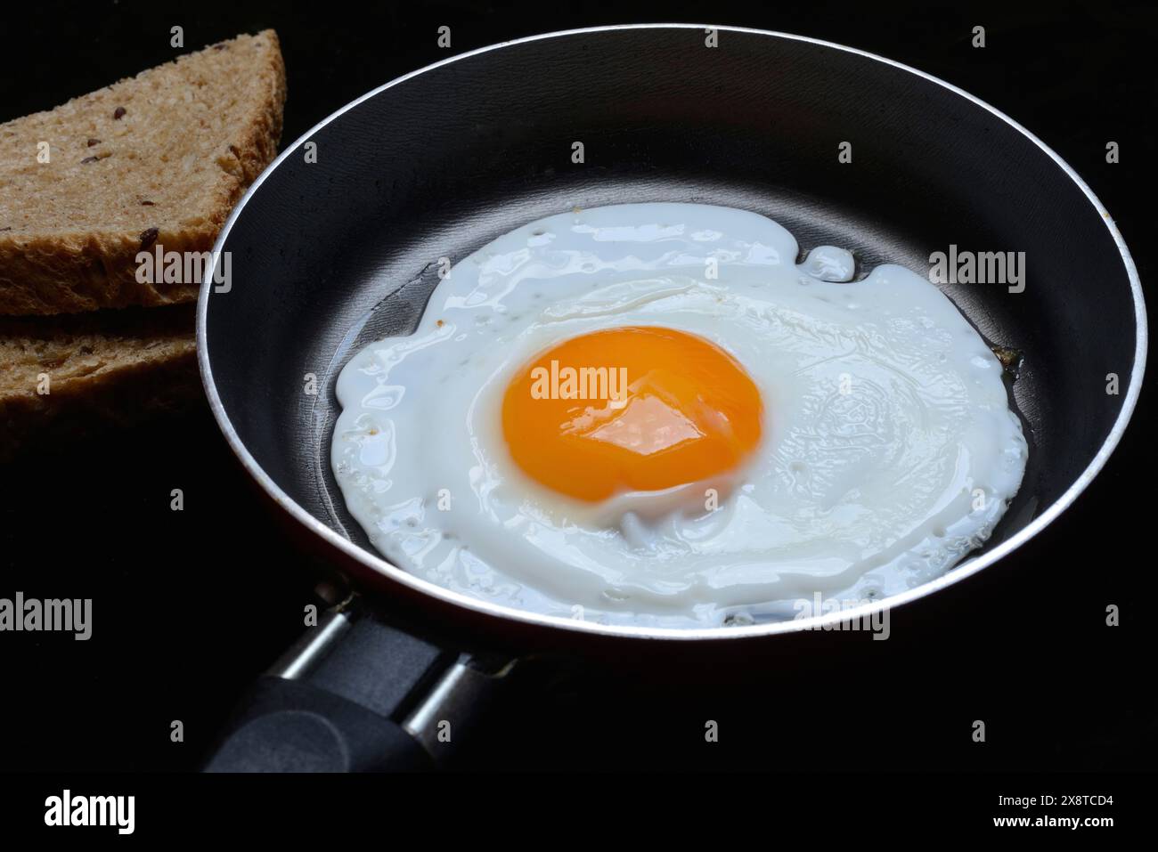Fried egg in a pan, fried chicken egg Stock Photo