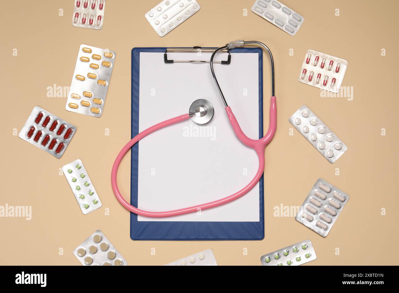 Stethoscope and clipboard surrounded by pills on beige background, flat ...